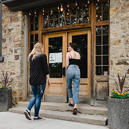 Two people walking into a building.