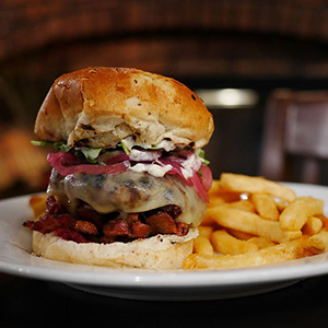 A hamburger with a side of fries.
