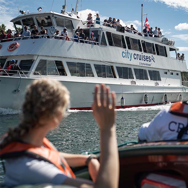 Person waves at tour boat
