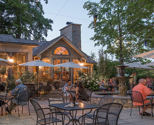 People sit on an outdoor patio at dusk.
