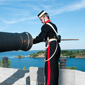 A person preparing a cannon at Fort Henry