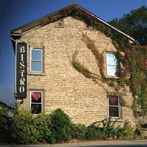 A historic stone building with ivy climbing along the walls.
