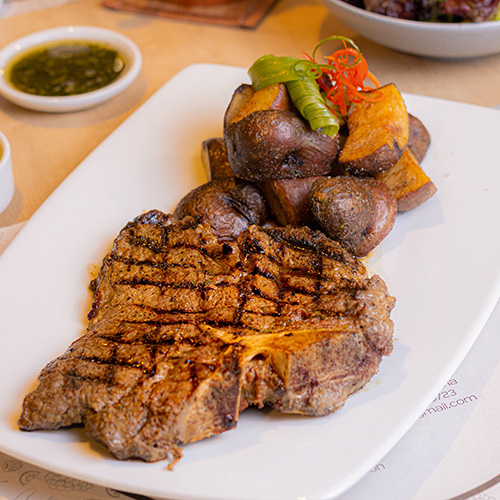 A steak with roasted potatoes.